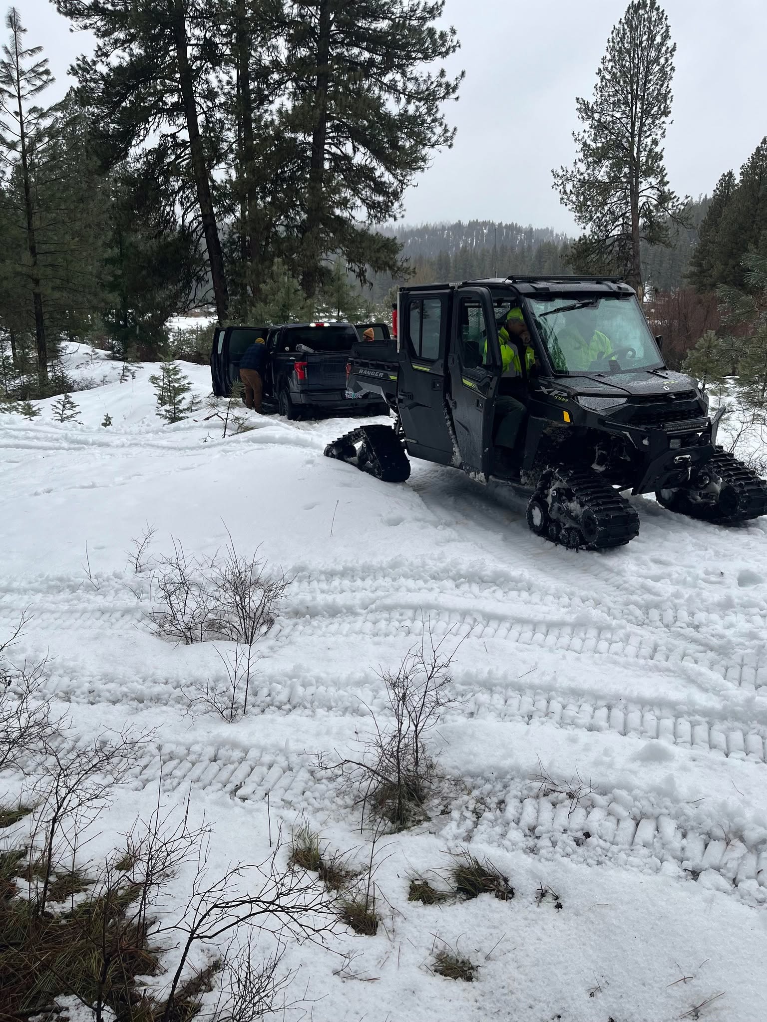 An image of a Side-by-side preparing to tow a truck.